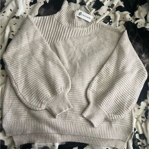 Arlo sweater by lily Lottie. Very soft knitted sweater not scratchy at all.
